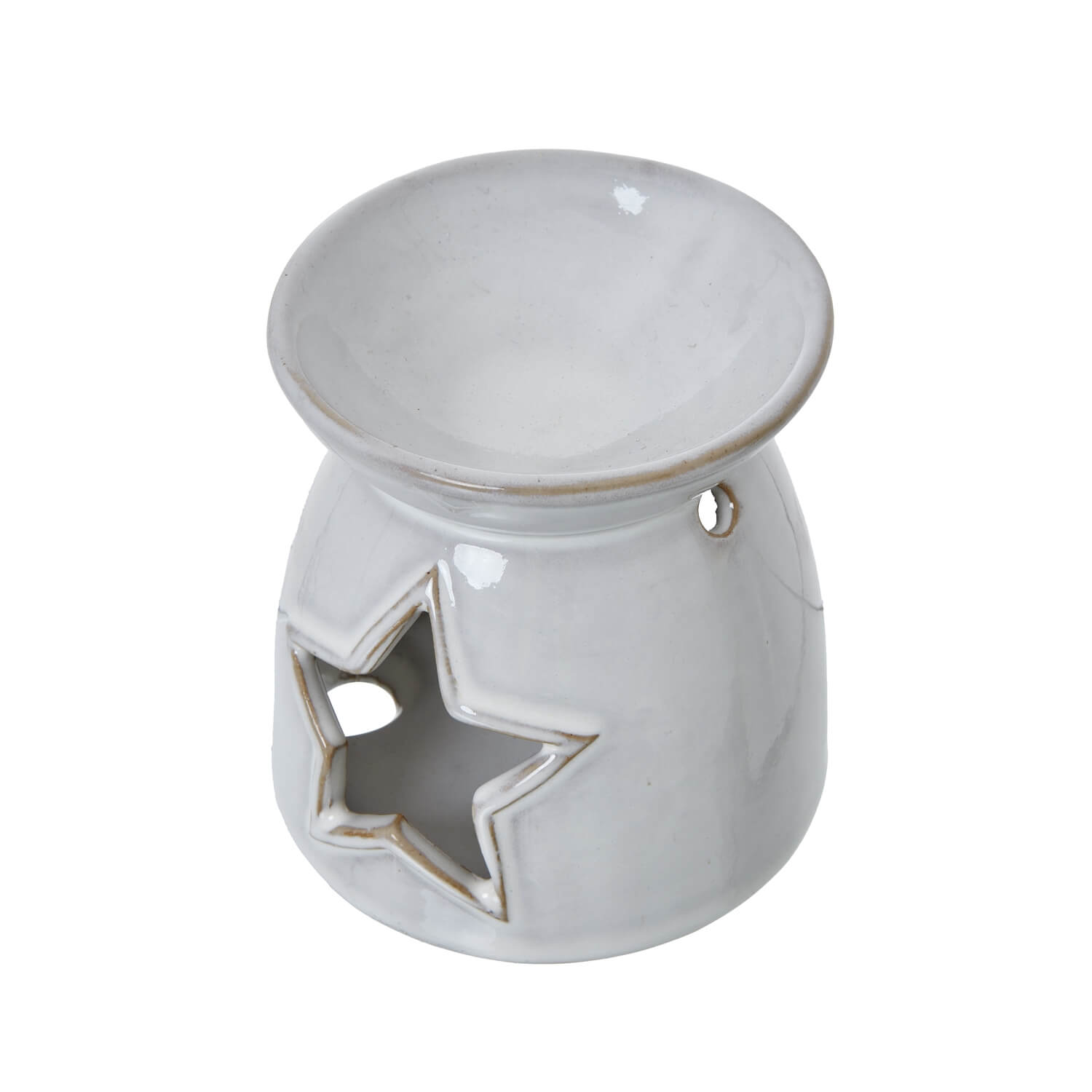 White ceramic tealight holder with star cut-outs casting intricate shadow patterns, perfect for wax melts or candles by sostter at brixbailey.com