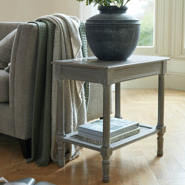 Handwoven rattan side table with tapered legs in soft grey, 60cm height, modern organic texture for coastal or minimalist decor by Sostter at brixbailey.com