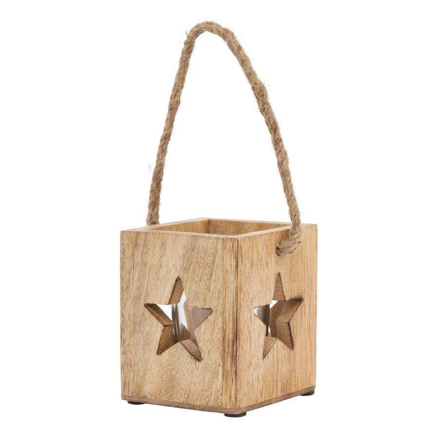 Handcrafted wooden star tealight holder with cutout design, casting warm star-shaped shadows, rustic brown finish. by Hill Interiors at brixbailey.com