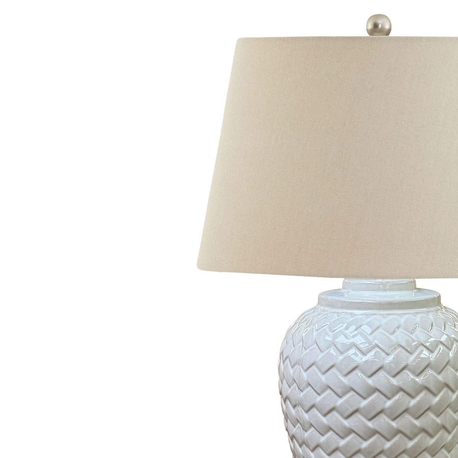 Handcrafted white ceramic chevron table lamp with linen shade, casting warm light patterns for modern home decor. by Sostter at brixbailey.com
