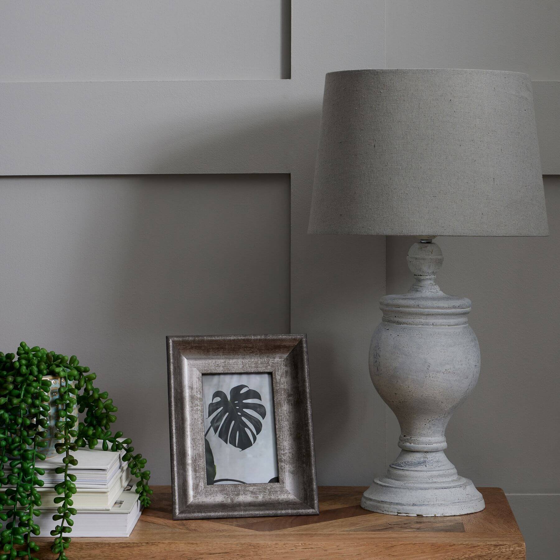 Uthina table lamp with wood base and linen shade in warm beige, creating cozy ambient lighting by Sostter at brixbailey.com