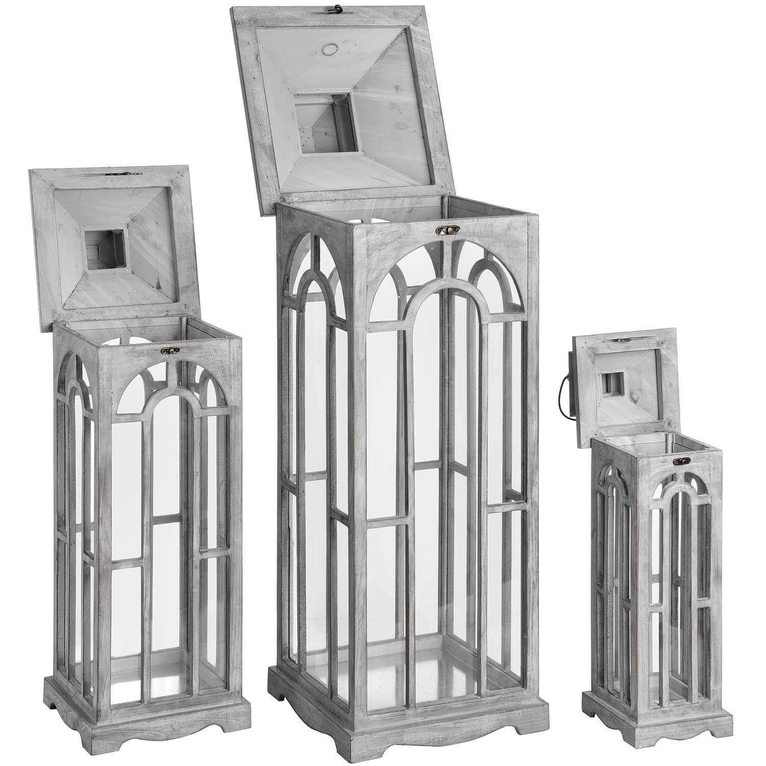 a playful trio of white-wash wooden archway lanterns casting fun, dappled light patterns on a surface