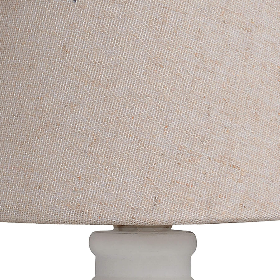 Handcrafted beige Cyrene table lamp with oatmeal shade and white wooden base for warm, elegant lighting. by Hill Interiors at brixbailey.com