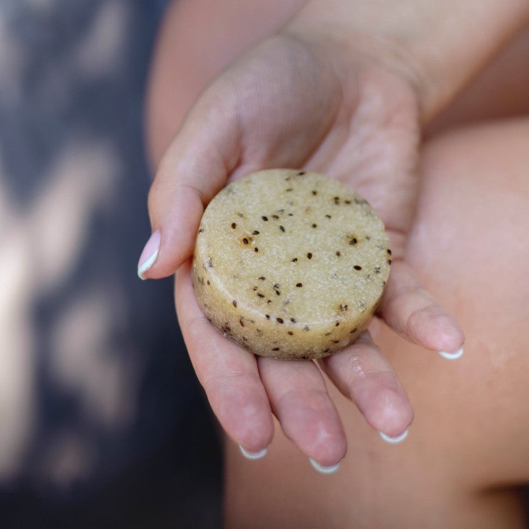 elegant kiwi seed body scrub bar with lemongrass, resting on a marble tray for spa-like luxury