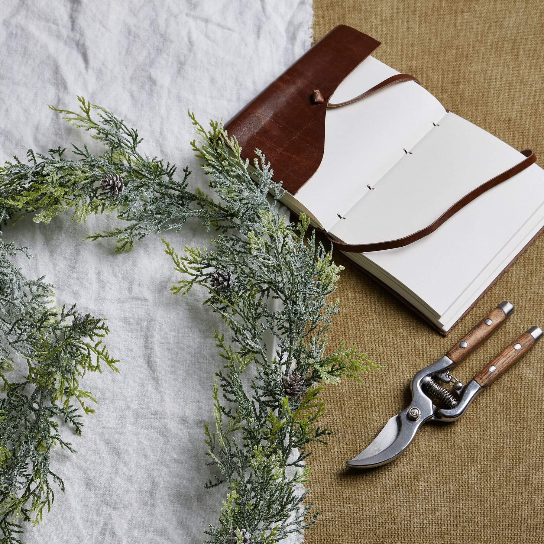 Frost-dusted pine garland with lifelike needles and pinecones, natural white with sparkling frost accents, 180cm long. by sostter at brixbailey.com