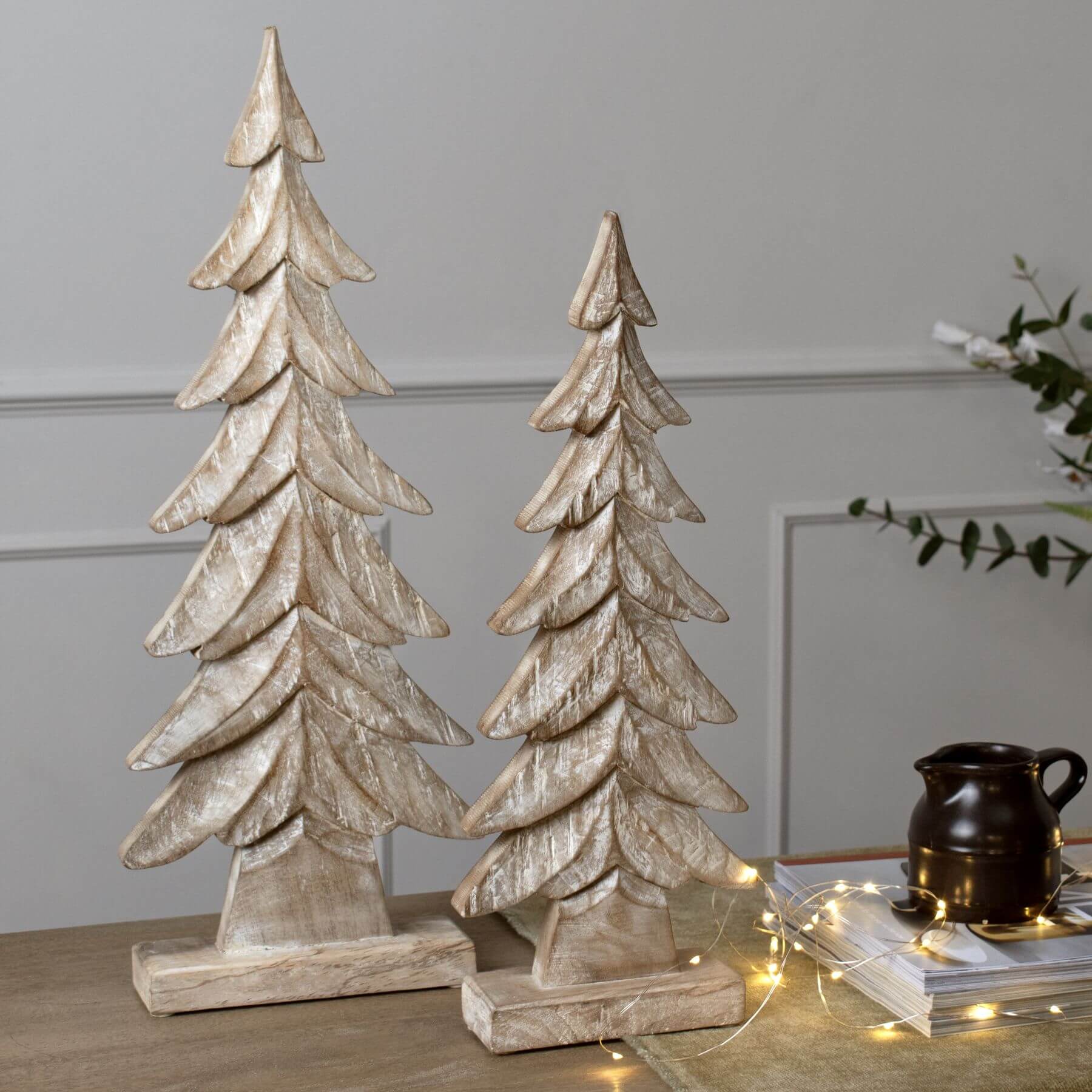 elegant handcrafted wooden christmas tree on a mantel with soft evening lighting