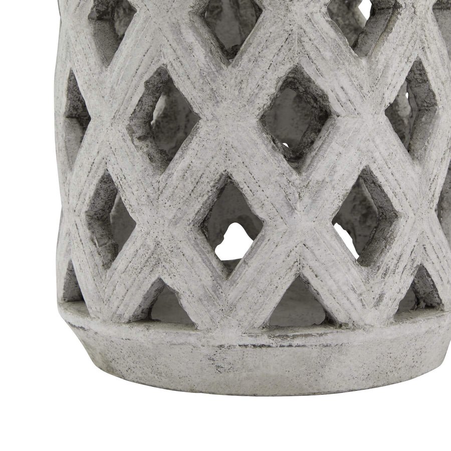 Handcrafted white ceramic stone lattice lantern with weathered finish, casting intricate geometric light patterns. by Sostter at brixbailey.com