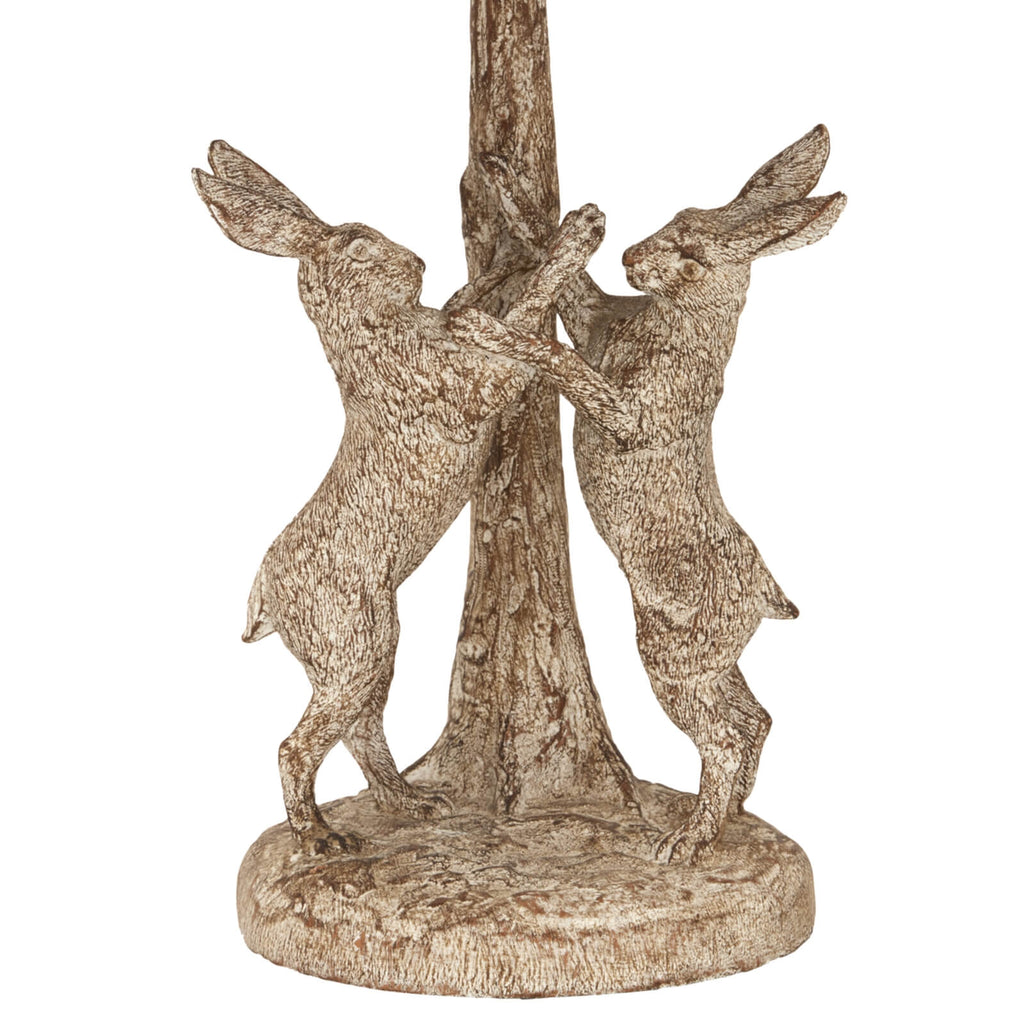 Stonewashed resin table lamp with marching hares design, natural linen shade, earthy brown and grey tones. by Sostter at brixbailey.com