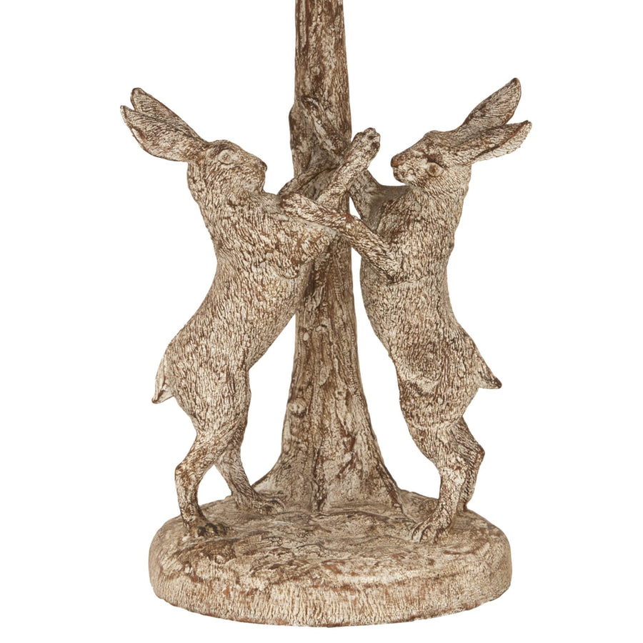 Stonewashed resin table lamp with marching hares design, natural linen shade, earthy brown and grey tones. by Sostter at brixbailey.com
