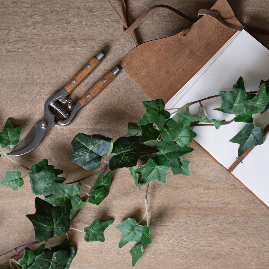 Lush artificial ivy garland with realistic silk leaves in natural green hues, perfect for mantels and wedding decor by Sostter at brixbailey.com