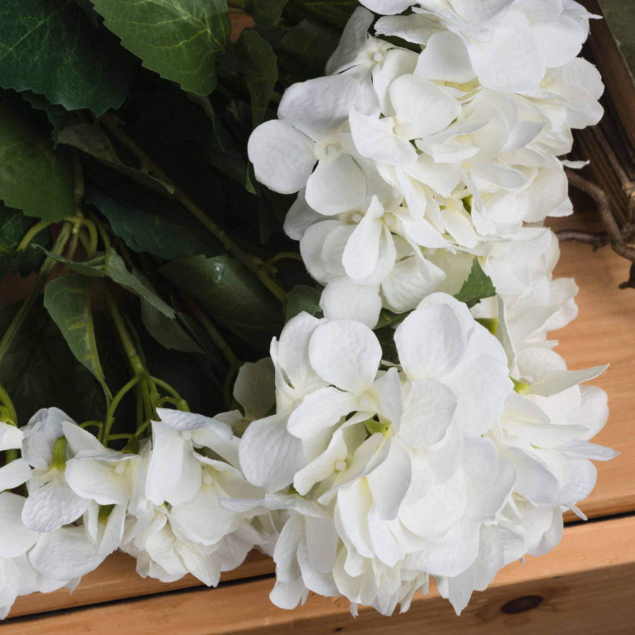 Lifelike creamy white hydrangea bouquet with realistic petals, perfect for elegant home decor or floral arrangements. by Sostter at brixbailey.com