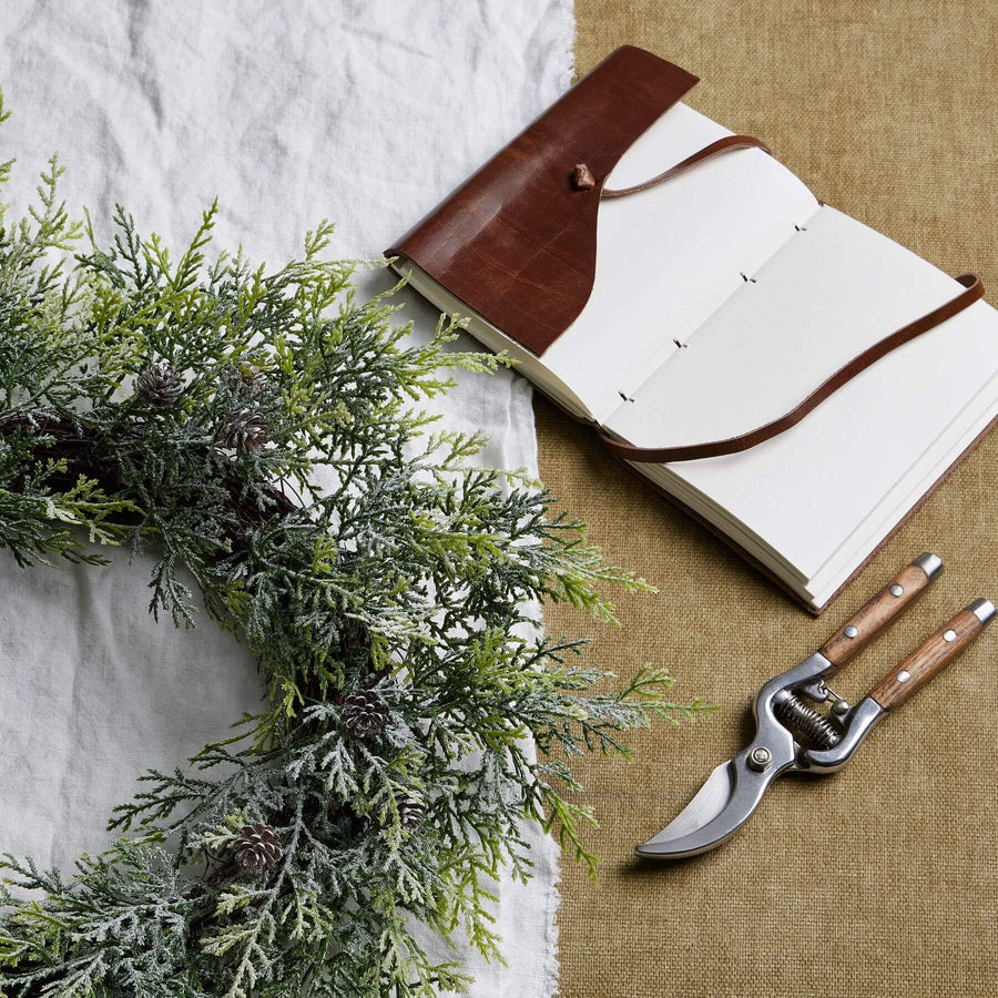 Frosted pine wreath with realistic frost effect, pinecones, and silver-green accents for winter home dÃ©cor. by Sostter at brixbailey.com