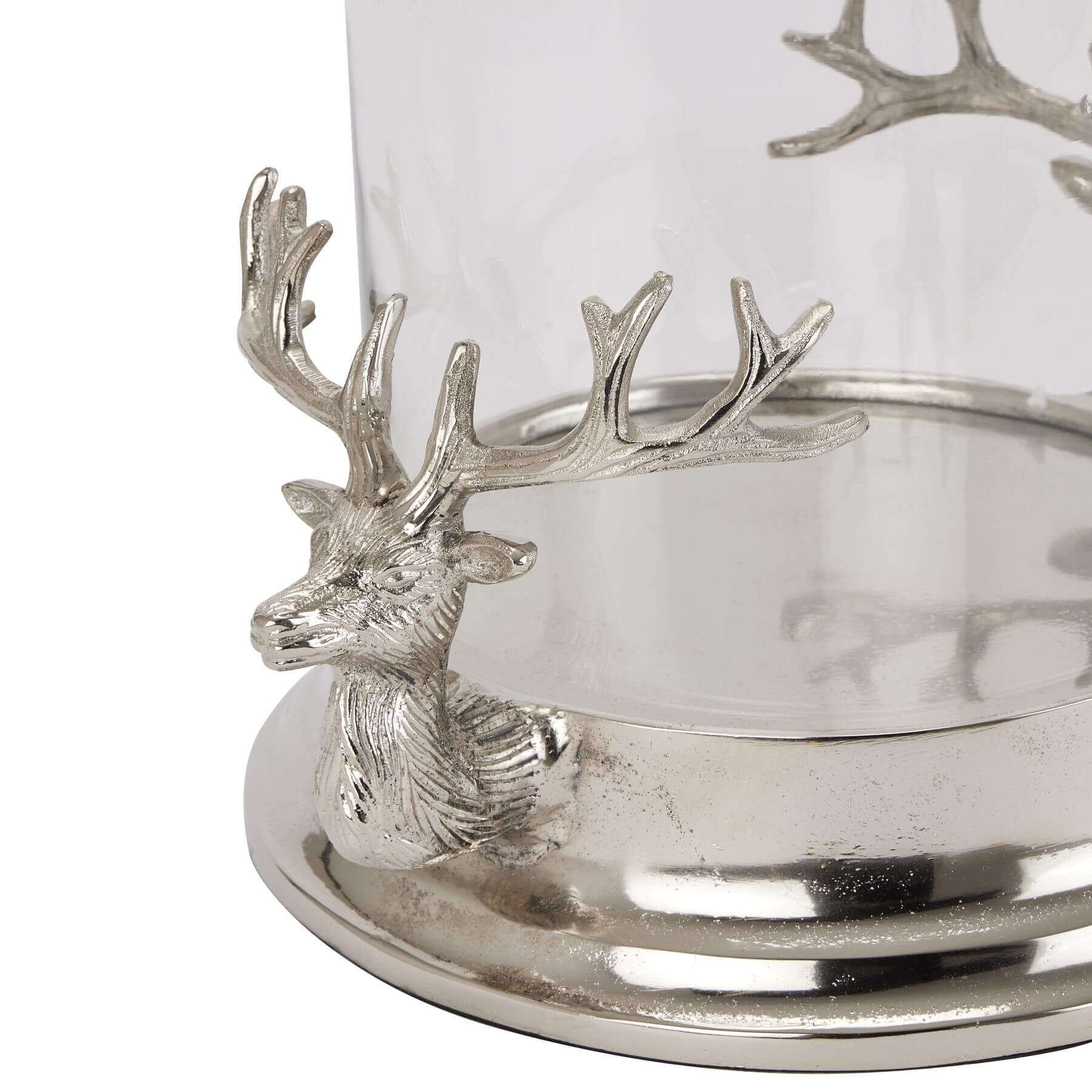 Silver stag heads hurricane lantern with glass cylinder, polished metal finish, elegant home decor lighting piece by Sostter at brixbailey.com