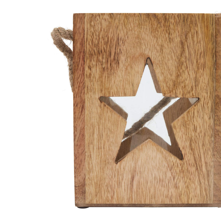 Handcrafted wooden star tealight holder with celestial design, casting warm glow in rustic brown finish for boho home decor. by Sostter at brixbailey.com