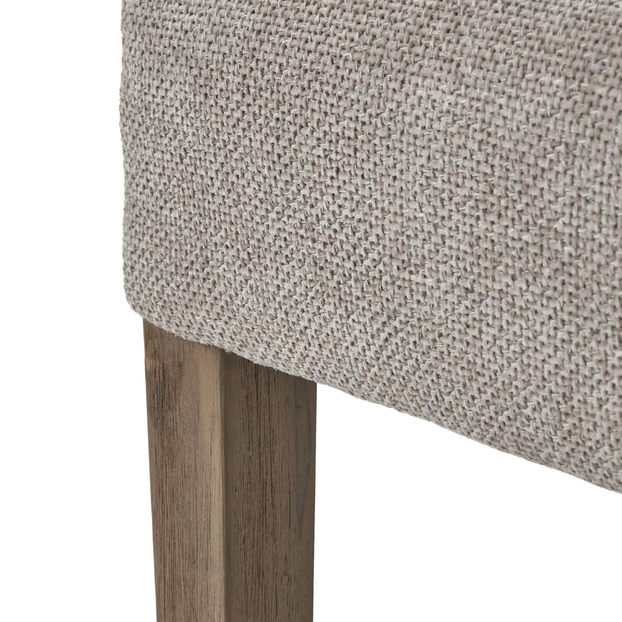 Taupe woven dining chair with dark wood frame, handwoven fabric upholstery, and curved ergonomic silhouette by Sostter at brixbailey.com