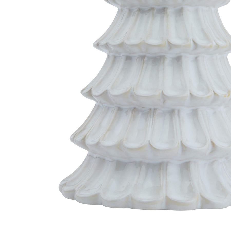 Handcrafted white ceramic fir tree sculpture with minimalist Nordic design, casting geometric shadows. by Sostter at brixbailey.com