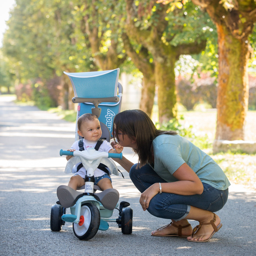playful blue baby tricycle with sun visor and storage bag, ready for sunny park adventures