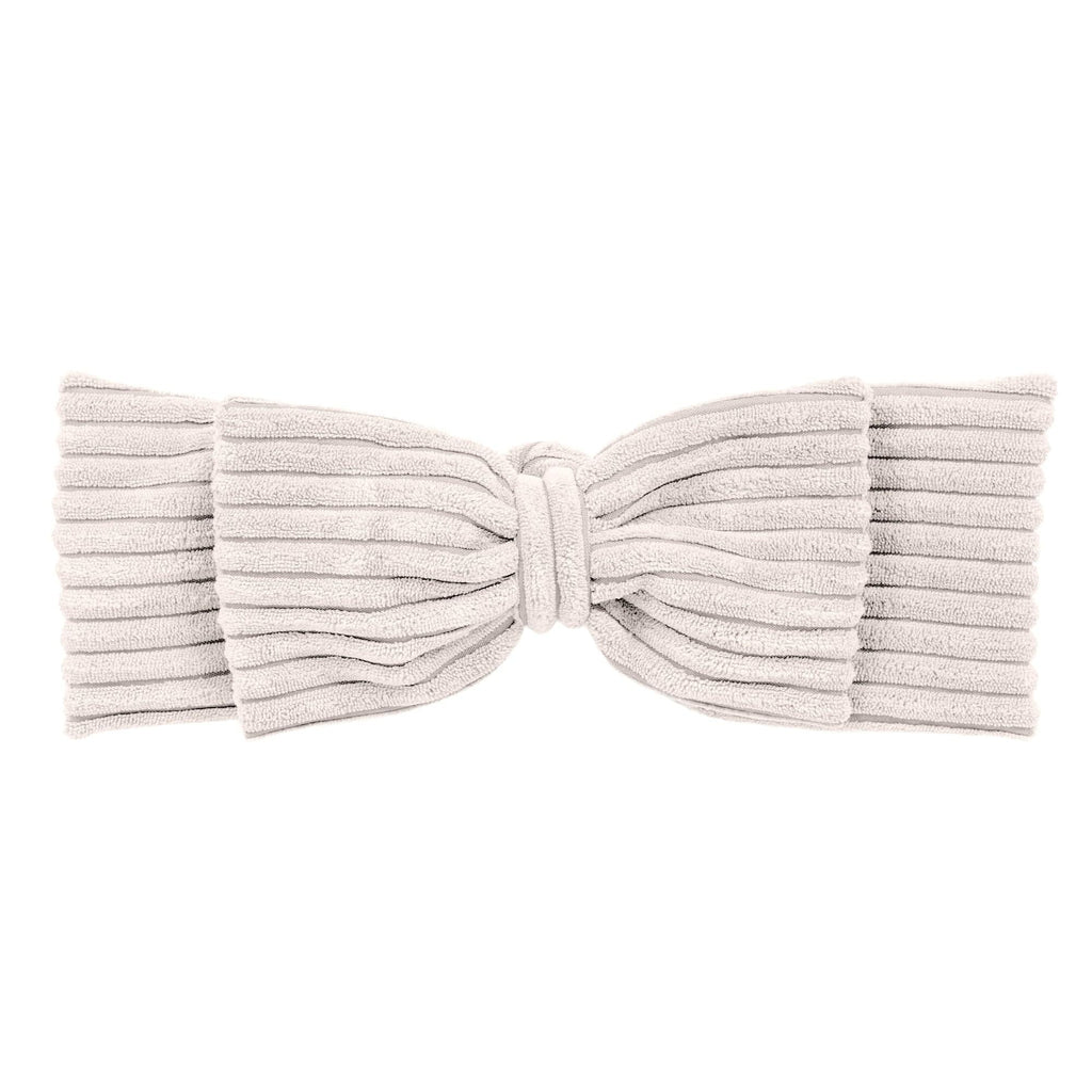 playful baby nest with a long braided bumper on a soft rug, perfect for a cozy play mat