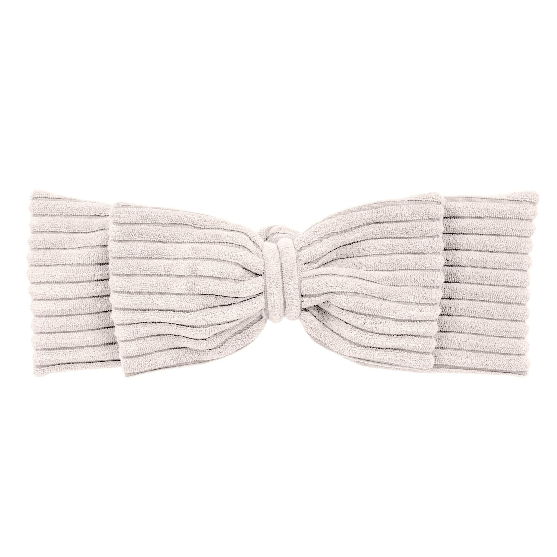 playful baby nest with a long braided bumper on a soft rug, perfect for a cozy play mat