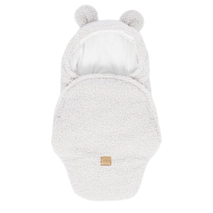 confident shot of a beige baby swaddle with bear ears, showcasing its soft ribbed corduroy texture and elegant bow
