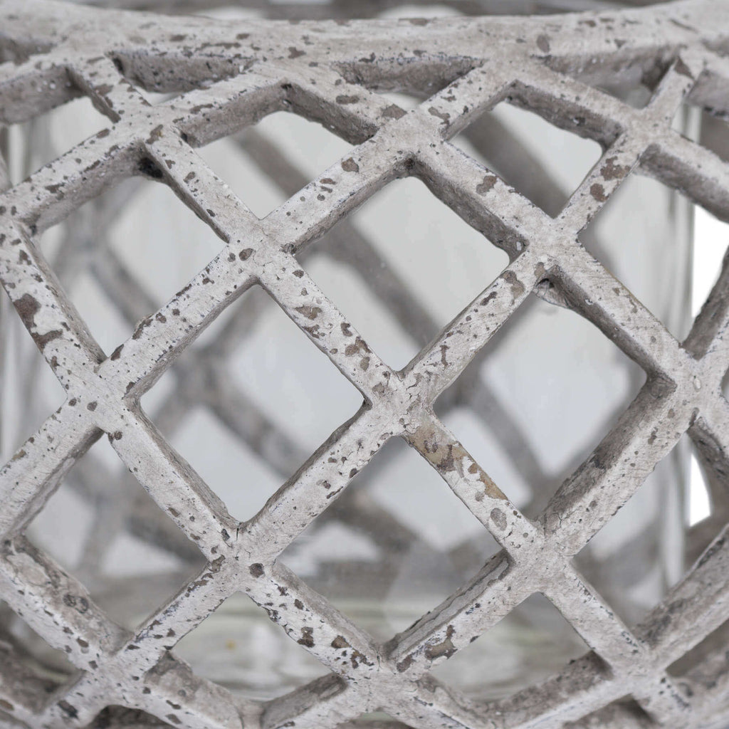 Round ceramic lattice hurricane lantern in natural stone, 17cm wide with intricate cutouts for ambient lighting. by Sostter at brixbailey.com