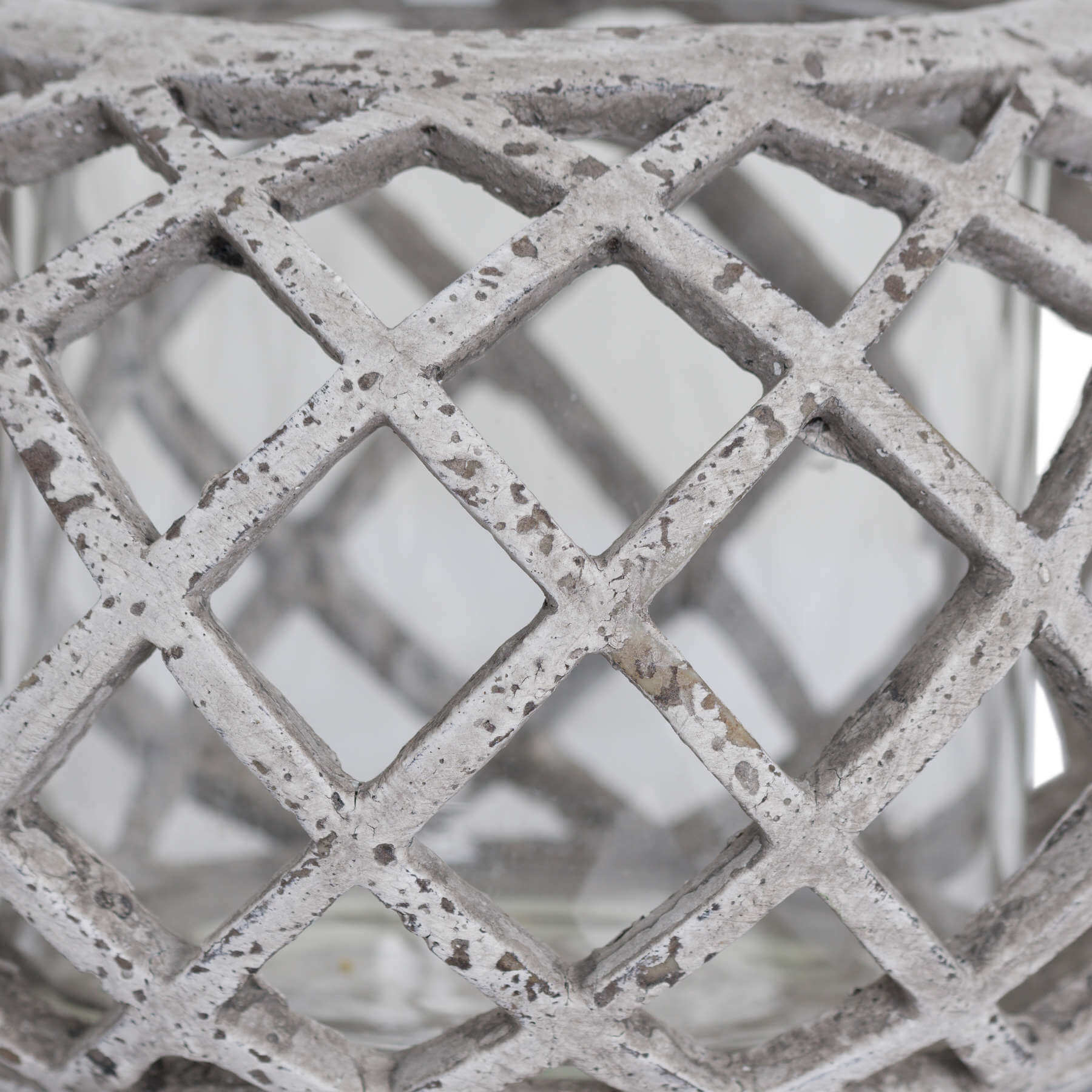 Round ceramic lattice hurricane lantern in natural stone, 17cm wide with intricate cutouts for ambient lighting. by Sostter at brixbailey.com