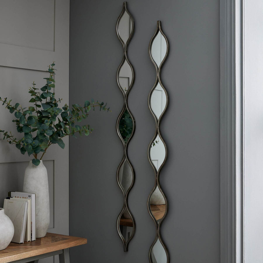 Decorative hanging silver mirror with slim frame, 146cm tall, reflecting light for modern or vintage decor by Sostter at brixbailey.com