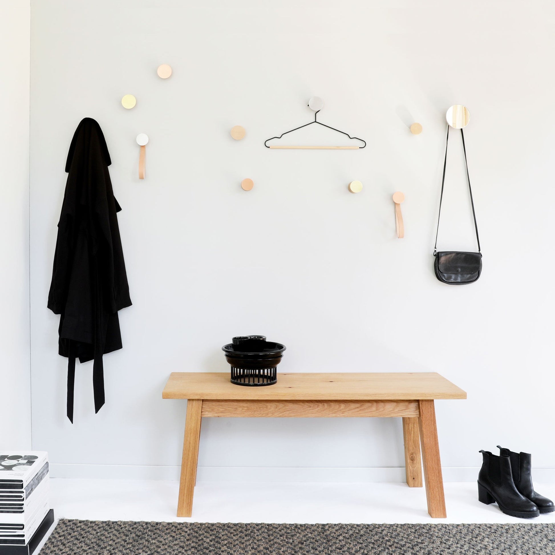 elegant beech wood and aluminium wall hook in a refined close-up, highlighting the warm grain and brushed metal finish