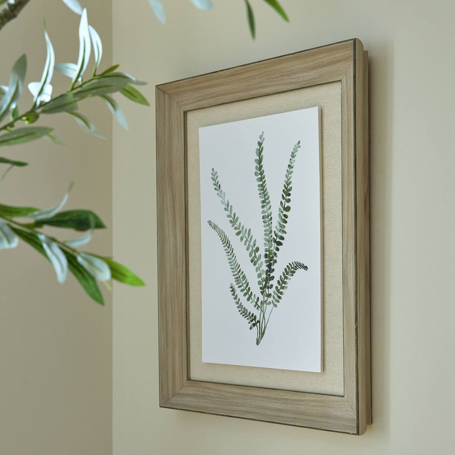 Hand-painted fern watercolor print in soft hues with rustic wood frame, botanical wall art for nature-inspired decor. by Sostter at brixbailey.com