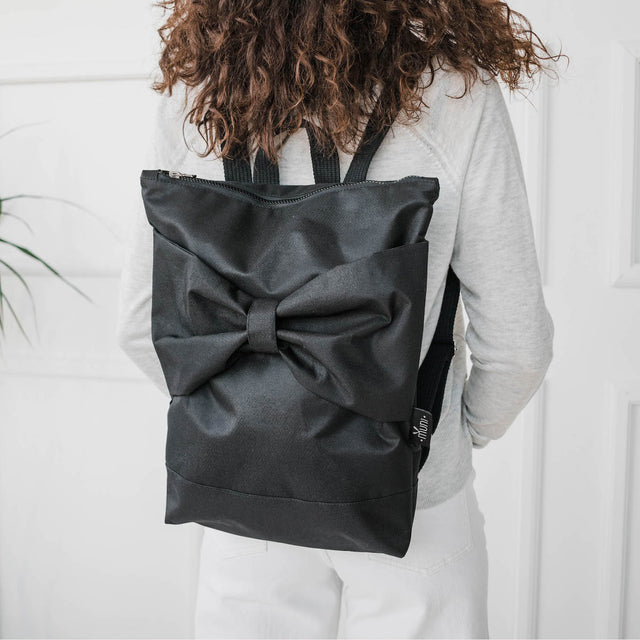 Chic Black Bow Backpack – Waterproof & Stylish for All-Day Use by Muni at brixbailey.com