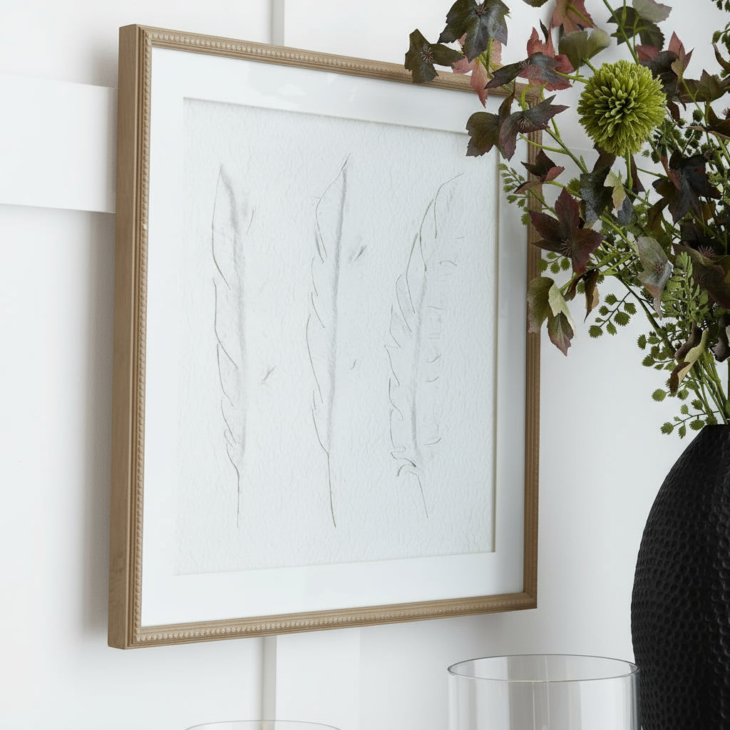 White feather artwork in champagne wood frame, textured minimalist design for modern interiors by Sostter at brixbailey.com