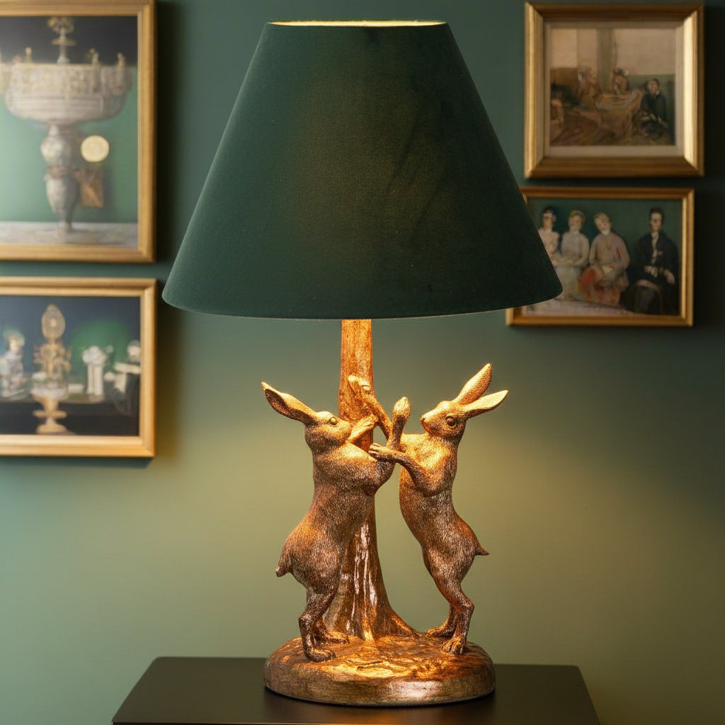 Antique gold marching hare lamp with green velvet shade, handcrafted resin sculpture, warm ambient lighting by RoomLondon at brixbailey.com