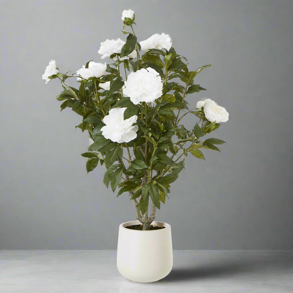 Lifelike white peony bush with lush green foliage, perfect for home decor, 106cm tall faux botanical arrangement by Sostter at brixbailey.com