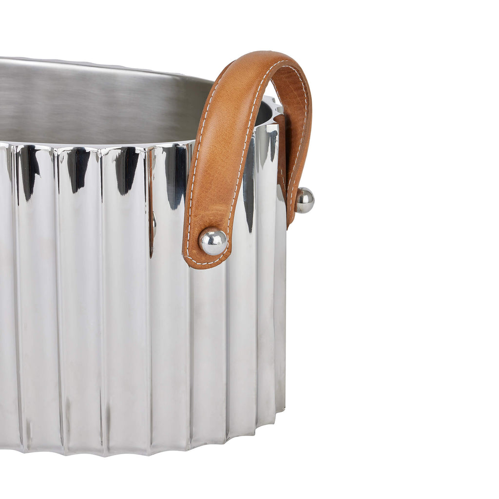 Silver champagne cooler with fluted design, leather handles, and mirror-polished finish for elegant entertaining by Sostter at brixbailey.com