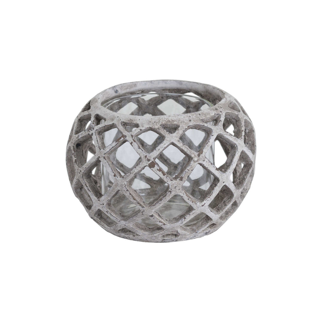 Handcrafted ceramic hurricane lantern with geometric lattice design, casting mesmerizing light patterns in neutral stone finish. by Sostter at brixbailey.com