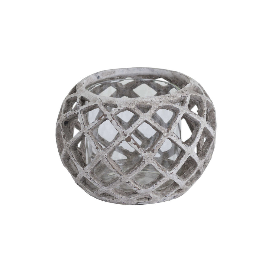 Handcrafted ceramic hurricane lantern with geometric lattice design, casting mesmerizing light patterns in neutral stone finish. by Sostter at brixbailey.com