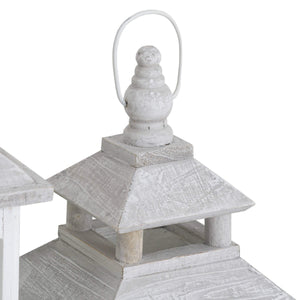 White wooden lantern with intricate window detailing, casting beautiful light patterns for coastal or Scandinavian decor. by Sostter at brixbailey.com