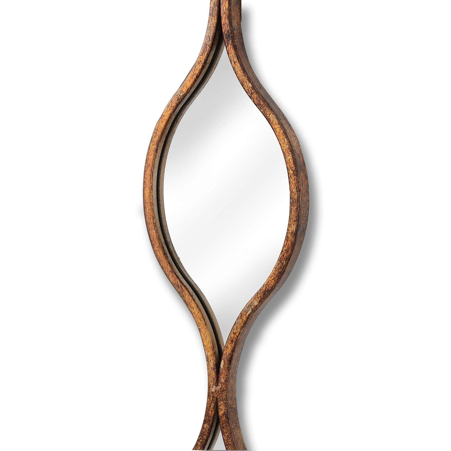 Aged gold wall mirror with warm patina, slim profile, and light-enhancing glass for elegant home decor by Sostter at brixbailey.com