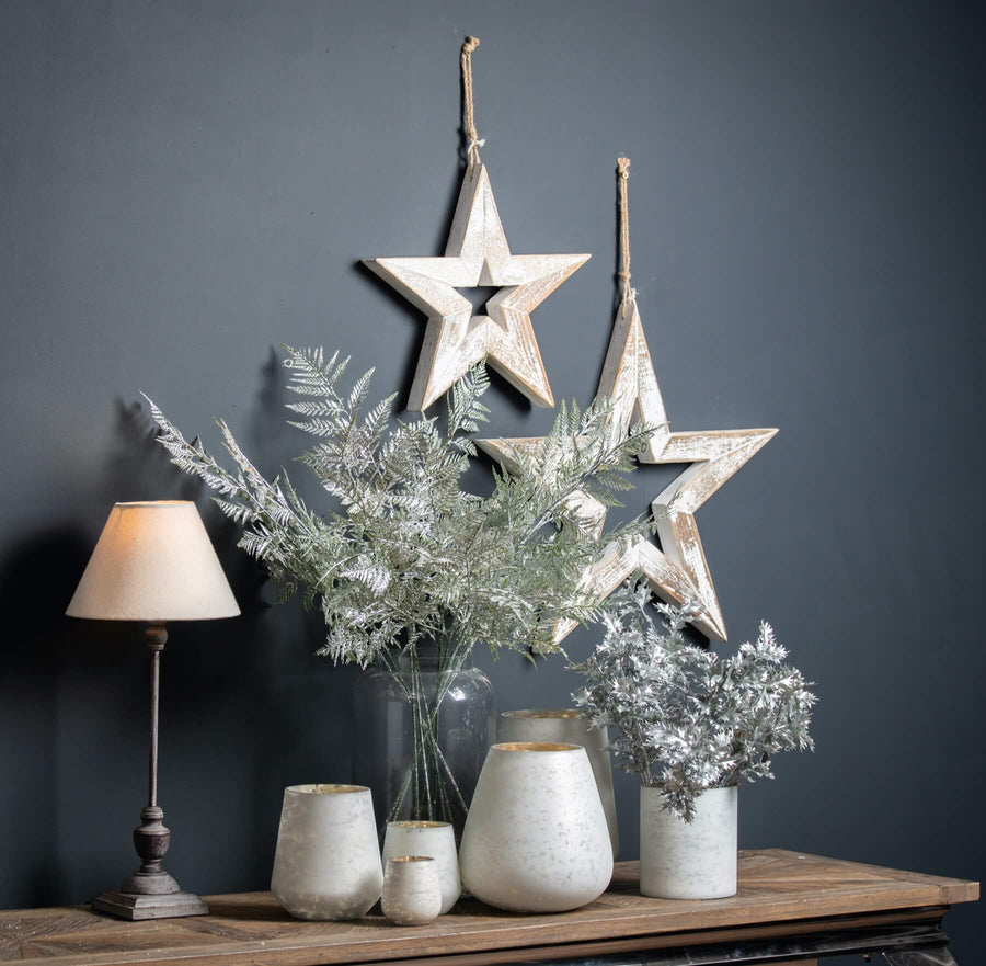 Handcrafted 50-inch wooden star decoration in antique white with sparkling accents, perfect for wall or centerpiece decor. by Sostter at brixbailey.com