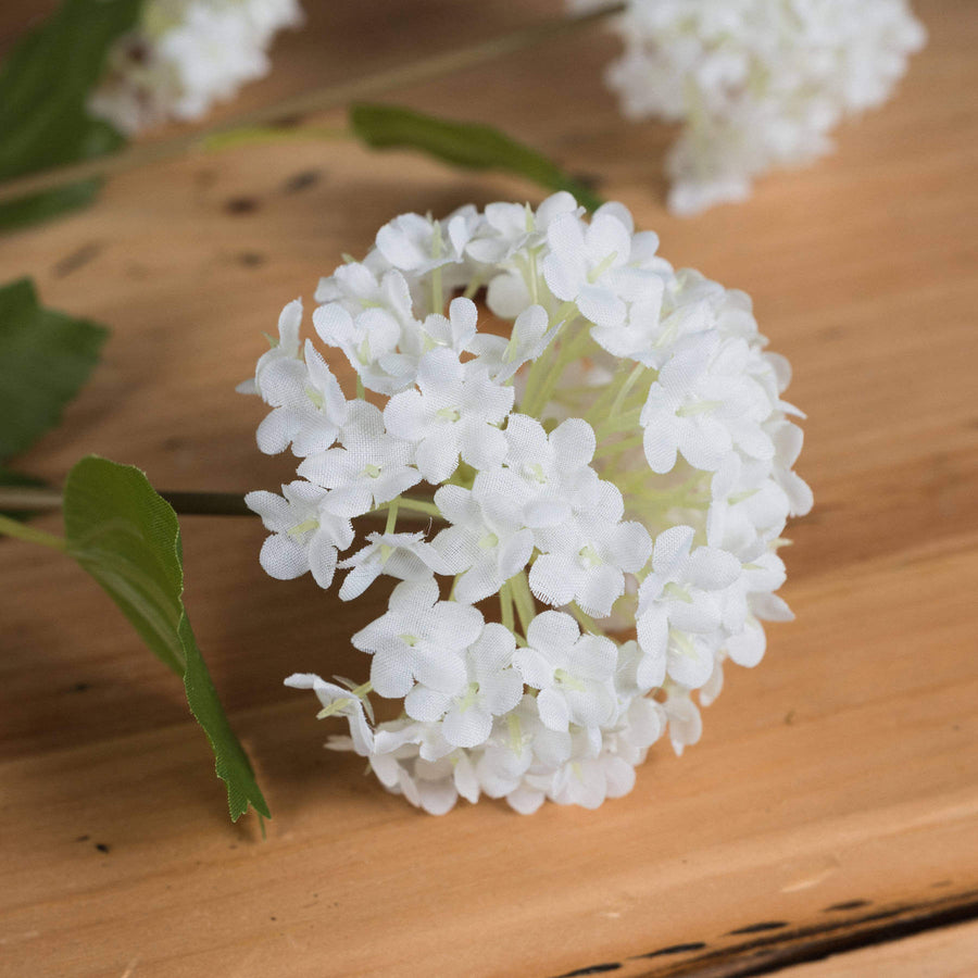Lifelike white faux snowball blossom stem, 75cm tall with realistic petals and flexible branches for home decor. by Sostter at brixbailey.com