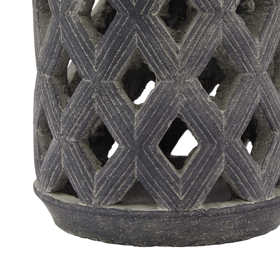 Grey lattice lantern with ceramic base and metal detailing, casting geometric shadow patterns for ambient lighting by Sostter at brixbailey.com
