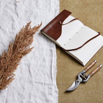 Lifelike faux pampas grass stem in soft taupe, 68cm tall, with natural movement for modern home decor by Sostter at brixbailey.com