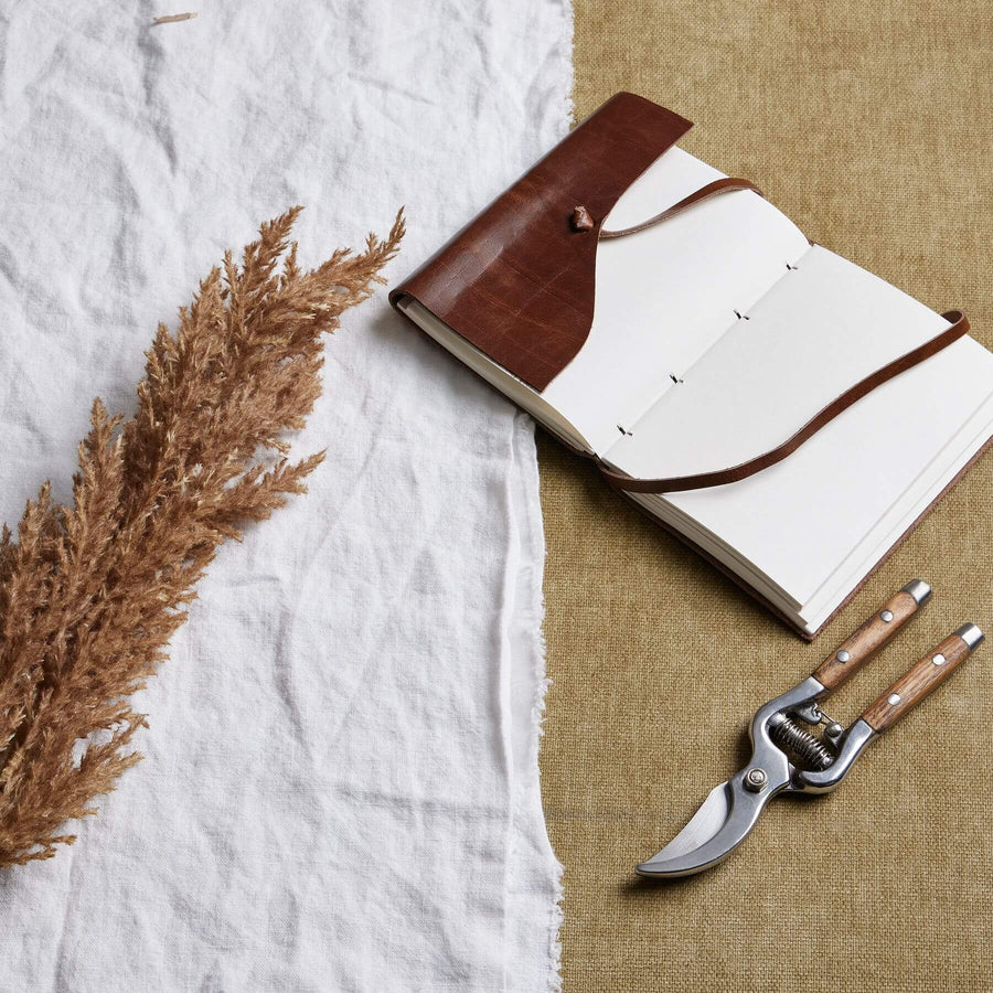Lifelike faux pampas grass stem in soft taupe, 68cm tall, with natural movement for modern home decor by Sostter at brixbailey.com