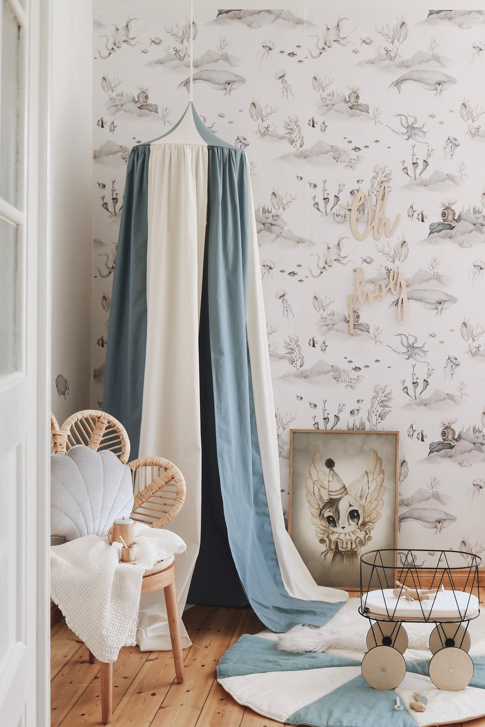 elegant blue circus canopy draped over a bed, showcasing its refined handmade linen texture