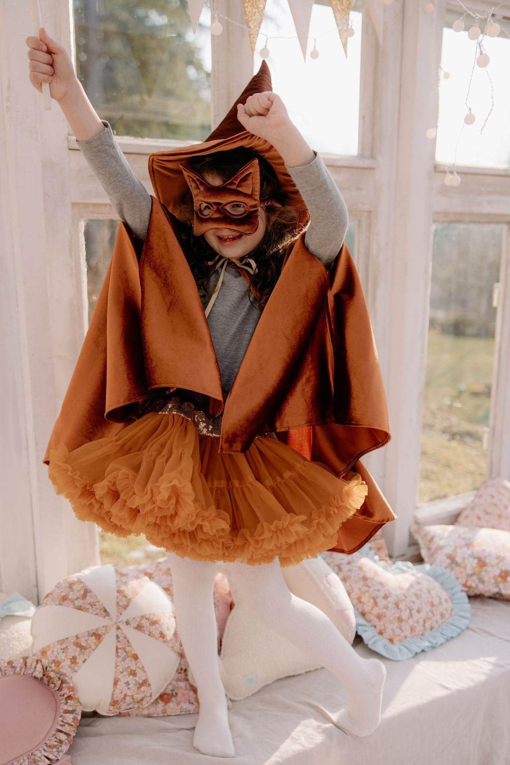 soft ginger velour cape with a deep hood, shown in gentle light for a comforting storybook feel
