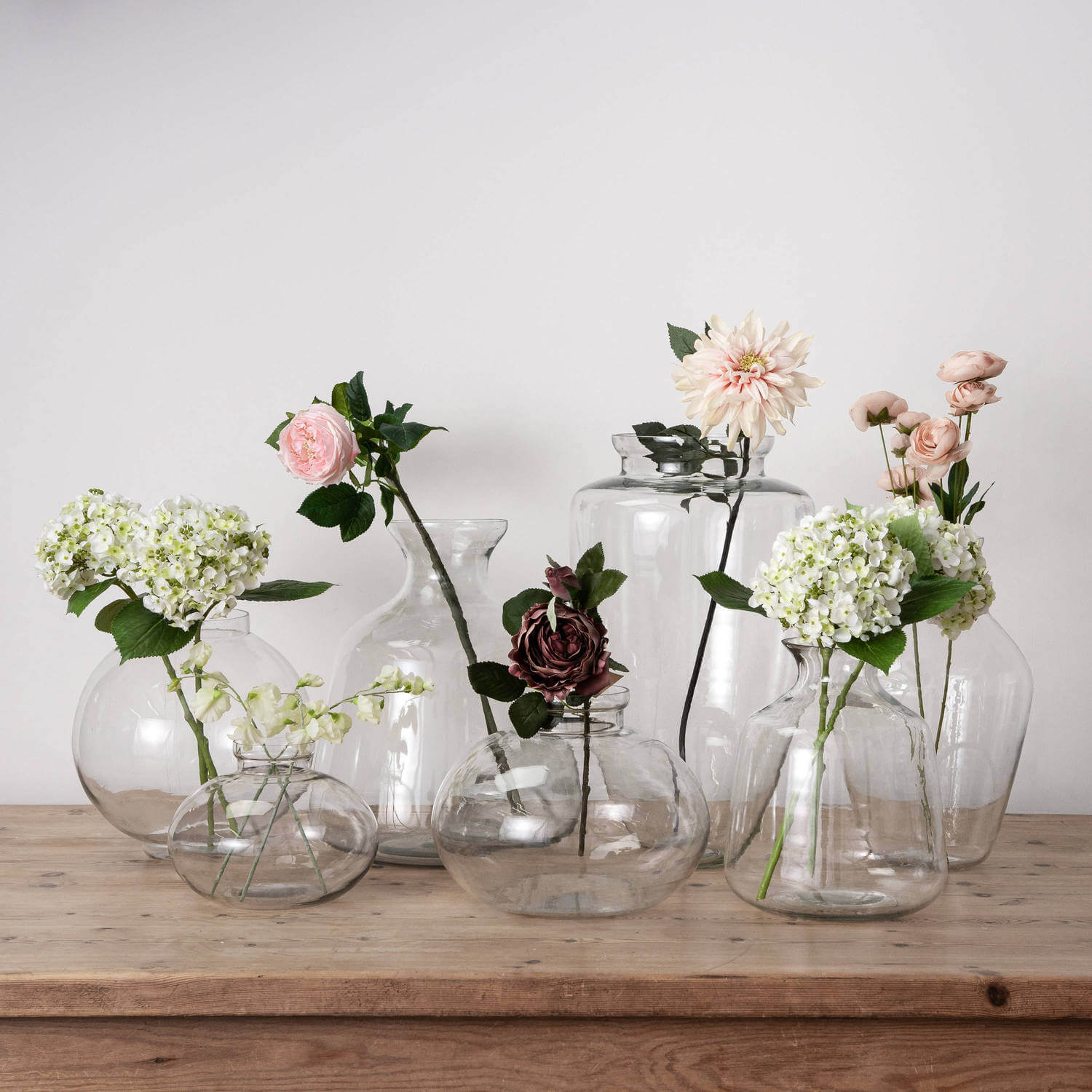 Clear glass Hydria vase with tapered neck and rounded base, inspired by ancient Greek design, for floral arrangements or decor. by RoomLondon at brixbailey.com
