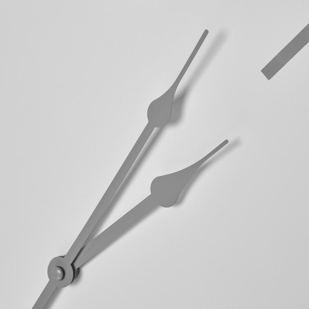 White minimalist metal wall clock with industrial-chic design, contemporary home decor statement piece by Sostter at brixbailey.com