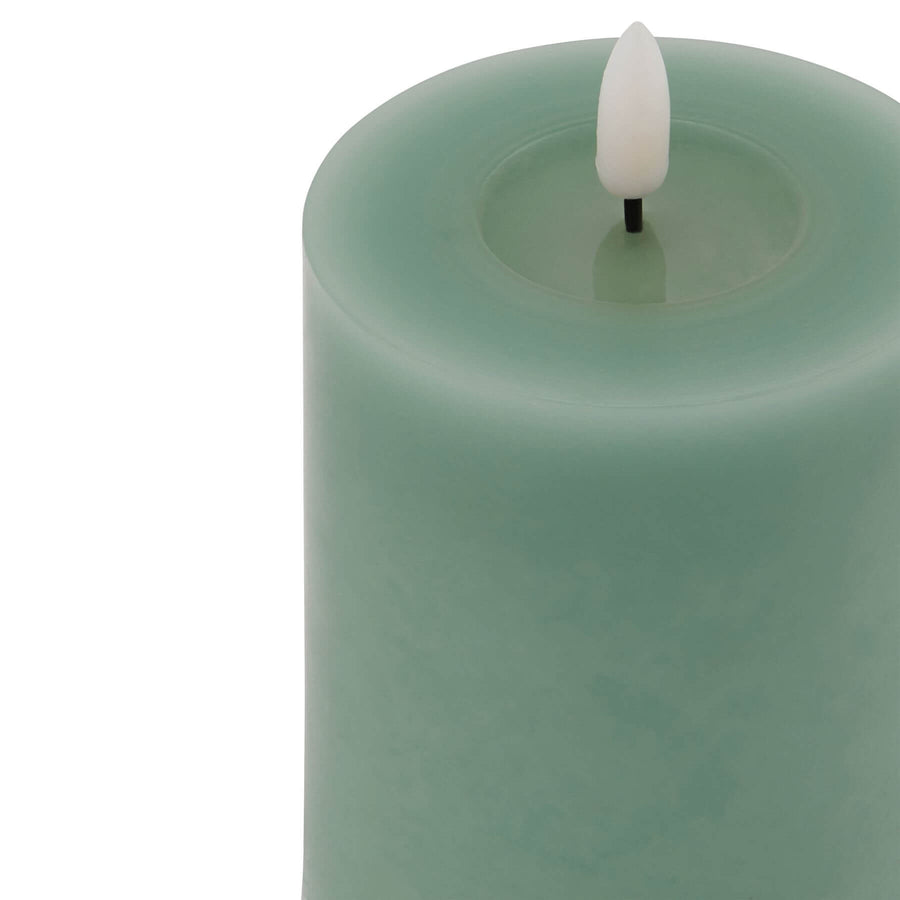 Realistic sage green LED wax candle with dripping details, flameless ambiance for modern decor  by Sostter at brixbailey.com