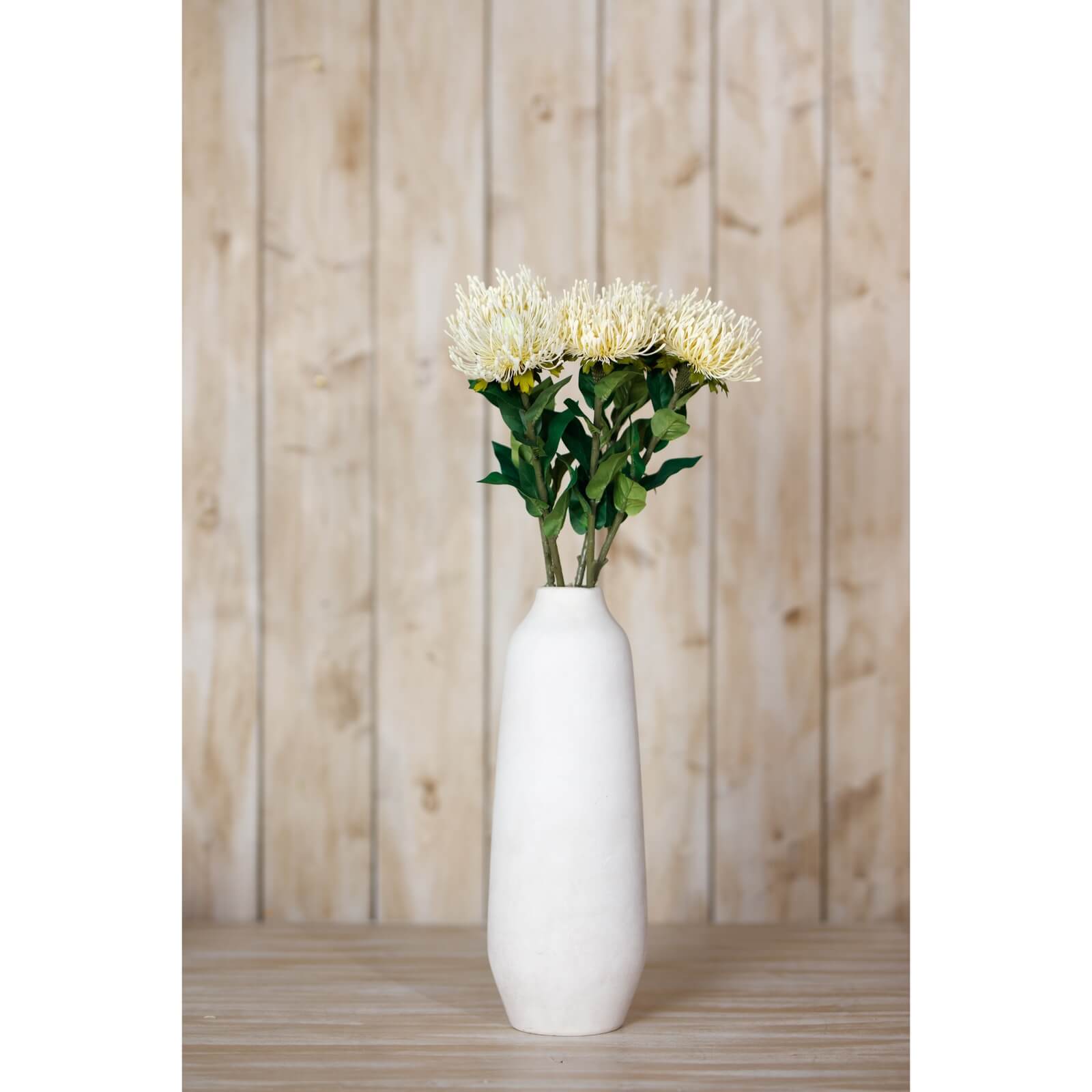 Cream Protea Lorea artificial stem with lifelike spherical bloom and lush foliage, soft cream color, 73 cm tall by Sostter at brixbailey.com