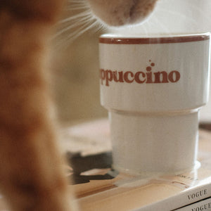 softly lit ceramic cappuccino mug with a comforting warm glow on a rustic table